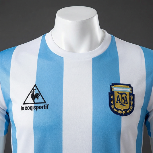 Blue and white striped sports jersey with Le Coq Sportif logo on a mannequin against a dark background
